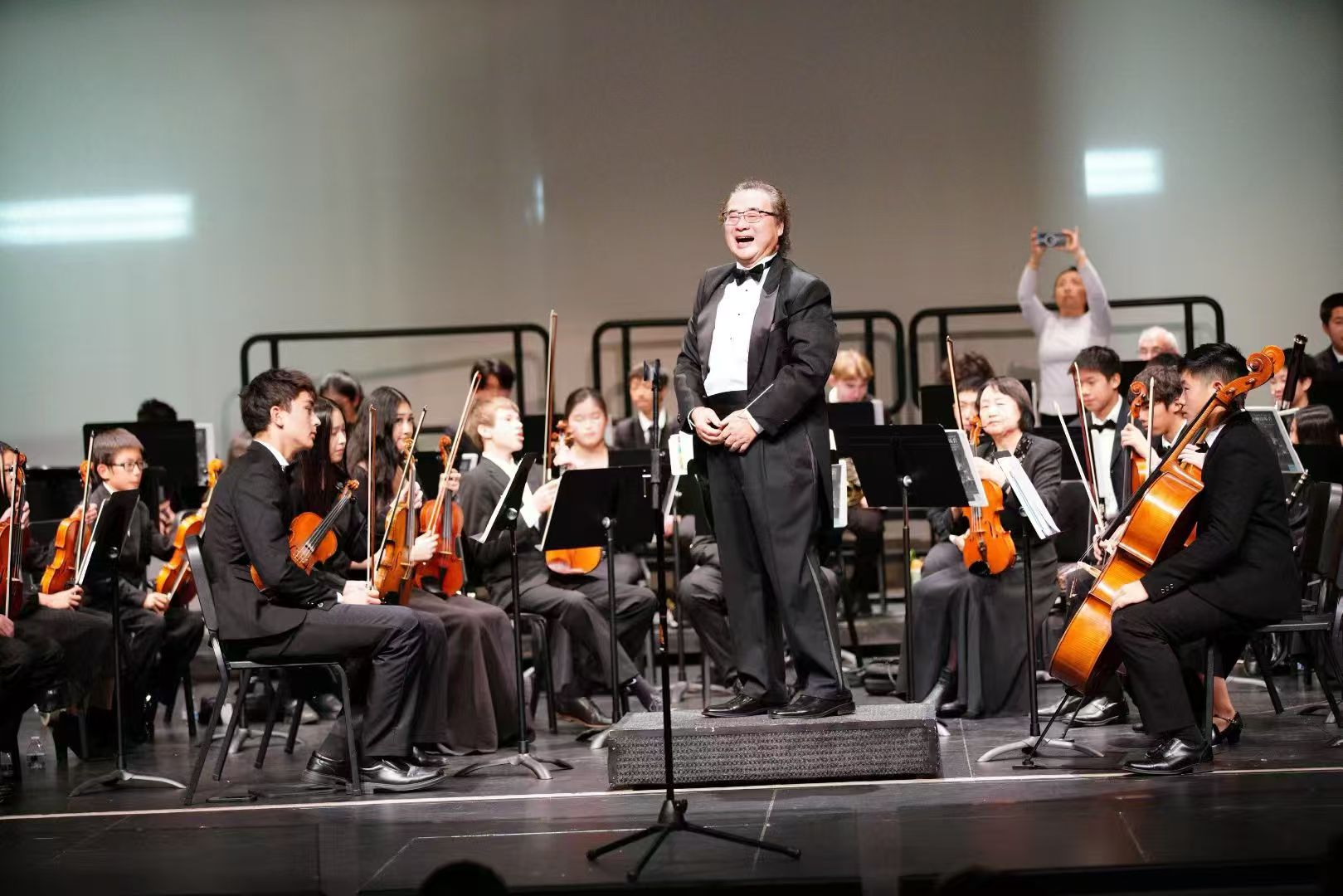 AmeriCal conductor and orchestra onstage