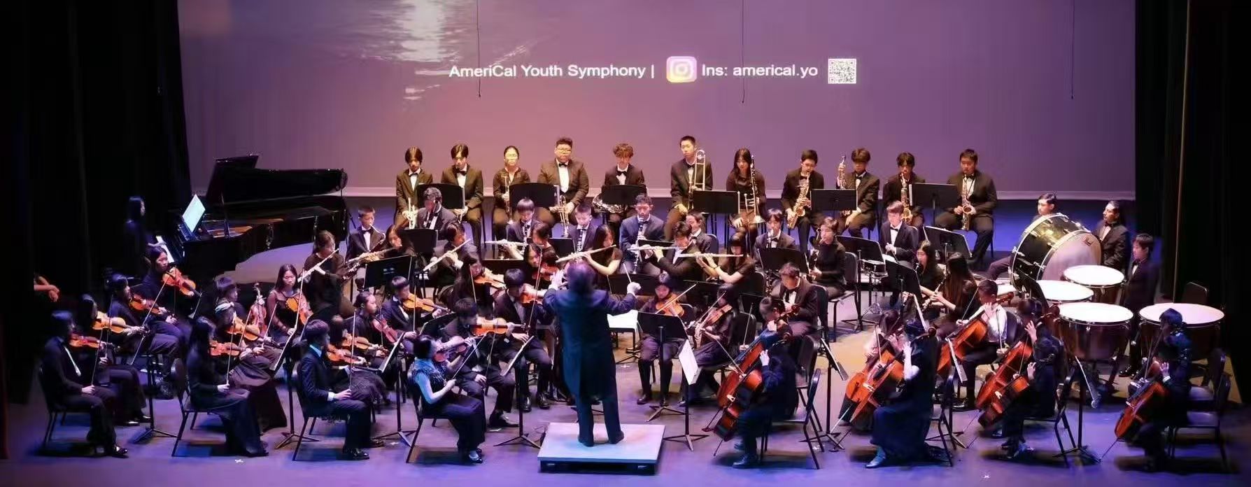AmeriCal Youth Symphony performing under purple stage lights
